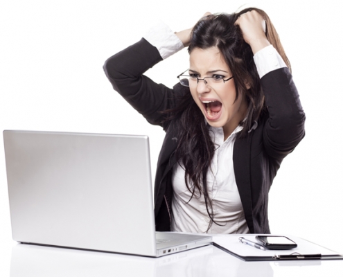 Woman at a computer pulling her hair out