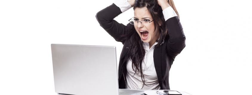 Woman at a computer pulling her hair out