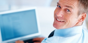 Businessman at a computer feeling good