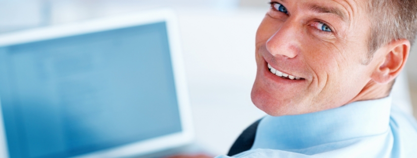 Businessman at a computer feeling good