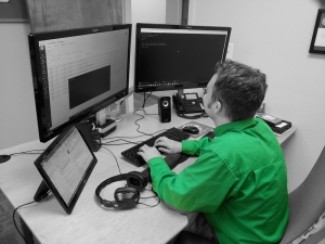 Simpleworks tech working at two monitors