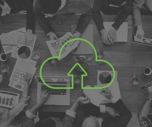 A team meeting with an overlay of a cloud upload icon