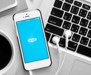 Phone laying on a keyboard with Skype opening