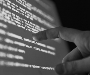 Finger pointing at lines of code