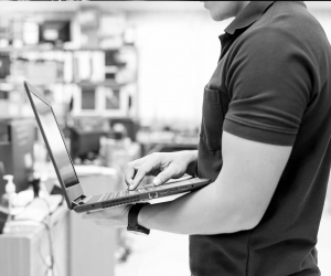 A Simpleworks tech works on a laptop