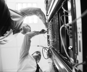 Two IT techs working on a server