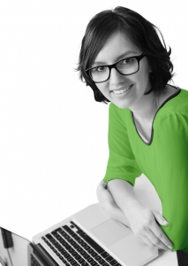 A smiling female Simpleworks professional at a laptop