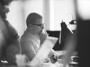 man thinking at a computer